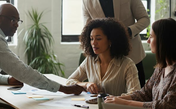 Woman at desk being instructed